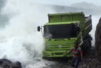 Dump truk yang terjebak di ruas jalan yang rusak di Ndondo Kecamatan Maurole Kabupaten Ende, Rabu (23/1), sedang diterjang gelombang pasang