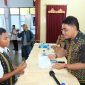 Anggota Komisi I DPR RI andreas Hugo Pareira sedang menyerahkan beasiswa Program Indonesia Pintar kepada salah satu siswa