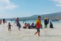 Pengunjung menikmati daratan di laut lepas pada Taka Embo Mina di perairan Laut Flores, Selasa (31/12)