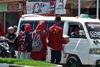 Aliansi HMI Sikka dan IMM Sikka sedang mengedarkan kotak amal dalam aksi kemanusiaan di depan Tugu Mof, Selasa (7/1)