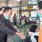 Petugas menyemprotkan cairan antiseptik kepada penumpang yang baru tiba di Bandara Frans Seda Maumere, Minggu (22/3)