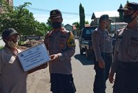 Kabag Ops Polres Sikka menyerahkan bantuan sembako kepada seorang sopir pangkalan, Selasa (21/4)