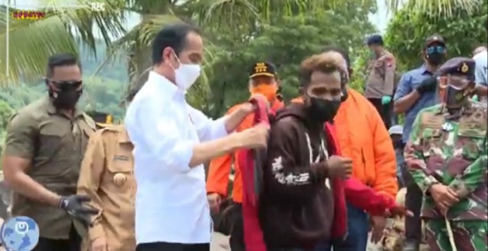 Presiden Jokowi mengenakan jaket merah miliknya kepada Frans Atawolo, Jumad (9/4) (foto: istimewa)