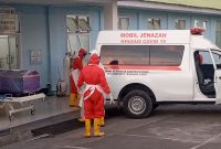 Petugas pemakaman sedang bersiap-siap mengevakuasi jenazah ke TPK Covid, Selasa (6/7)