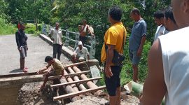 Warga perbaiki jembatan yang jebol di Dusun Kangarusa Dwsa Wolowiro, Jumat (21/1)