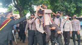 Beberapa polisi menggendong mantan Kapolres Sikka AKBP Sajimin, Sabtu (12/2)