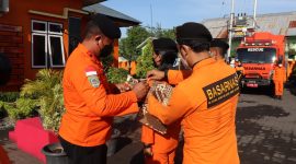 Kepala Kantor Pencarian dan Pertolongan Maumere I Putu Sudayana menyematkan pita kepada personil Siaga SAR Khusus Lebaran, Senin (25/4) (foto: istimewa)