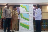 Kepala Stasiun Geofisika Kupang Margiono Peta Bahaya Tsunami 3 Kelurahan di Kota Maumere kepada Asisten Administrasi Umum Setda Sikka Robertus Ray, Selasa (6/12) di Aula Lantai 3 Kantor Bupati Sikka