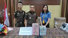 Istri tersangka Laurensius Gregorius menyerahkan uang ganti rugi kasus dugaan korupsi BTT, Senin (20/2)