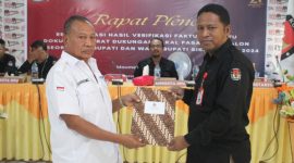 Ketua KPU Sikka Herimanto menyerahkan berita acara pleno rekapitulasi hasil verifikasi faktual pertama kepada Ketua Tim Pemenang Paket Flory-Ken, Rabu (10/7)